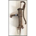 An early 20th century cast and wrought iron village water pump. The painted pump with reeded