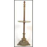 An early 20th century brass and marble standard lamp. Raised on a brass terraced half sphere base