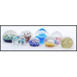 A selection of 20th Century glass domed paperweights to include millefiori, control bubble, spiral