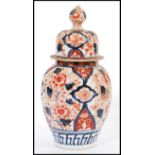 A 19th century Chinese Imari jar / vase / urn and cover having typical hand painted Imari decoration