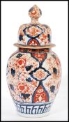 A 19th century Chinese Imari jar / vase / urn and cover having typical hand painted Imari decoration