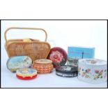A group of vintage items to include a collection of vintage tins, two woven bags, magazine rack