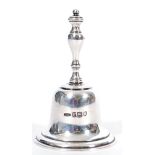An early 20th Century silver hallmarked table bell by Asprey having a baluster formed handle and a