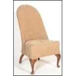 A mid 20th Century Victorian revival walnut spoonback nursing chair, with floral carved rail, button