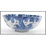A 19th century Chinese blue and white bowl of scalloped form having hand painted decoration
