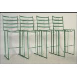 A set of four breakfast / bar / outdoor / garden stools, constructed from metal with ladder back