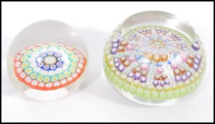 Two 20th Century paperweights to include a smaller glass domed paper weight with a coloured