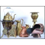 A large collection of vintage copper and brass wares to include a graduating set of brass jugs, blue