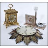 A group of three vintage retro 20th century clocks to include a battery movement antique style brass