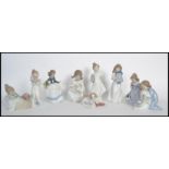 A collection of nao / NAO figurines to include a puppy with a Christmas stocking, a girl with a