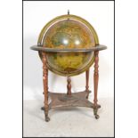 An antique style cocktail drinks cabinet in the form of a globe with hinged top section to fitted