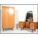 A mid 20th Century vintage Austinsuite bedroom suite in teak comprising of a dressing table with a