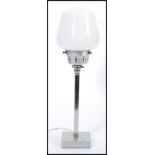 A vintage retro 20th century Art Deco influence table lamp raised on chrome square base with tall