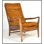 A vintage mid 20th Century open armed fireside beech armchair / elbow chair by Cintique, Raised on