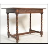 An 18th century Victorian Jacobean revival carved oak writing table desk being raised on block and