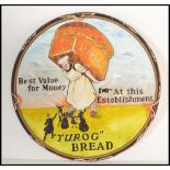 A contemporary recreation of a circular enamel advertising sign for Turog Bread, the sign hand
