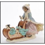 A Lladro figural group 'Sleigh Ride', No. 5037 boy and girl in sleigh pulled by a dog with leather