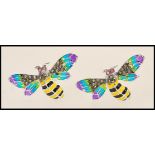 A pair of silver plique a jour cufflinks in the form of bees with green wings and set with