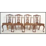 A set of four 19th Century Chippendale revival large mahogany dining chairs, each raised on cabriole