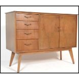 A vintage mid 20th Century walnut sideboard / credenza, having a central bank of three drawers