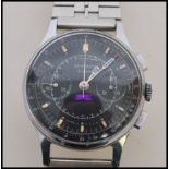 A vintage 1960's chronograph Sekonda 19 Jewels Tachymetre watch having a black enamelled face with