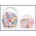 Two 20th Century scramble cane murano glass domed paperweights having latticino twists and