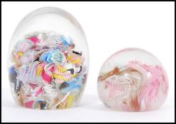 Two 20th Century scramble cane murano glass domed paperweights having latticino twists and