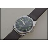 A vintage gentleman`s stainless steel HMT Jawan military wristwatch with black dial, Arabic numerals