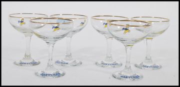 A set of six vintage retro 20th century Babycham advertising glasses raised on circular bases with