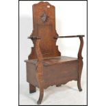 A 1920's oak Jacobean revival JAS Shoolbred of London oak hall settle chair / bench. The seat with