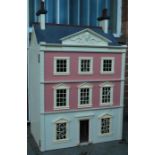 A vintage 20th century good sized dolls house having large hinged door with multiple rooms, stairway
