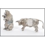 Two signed silver plated ornaments to include a highland cow having a glass control bubble centre