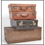 A stack of vintage suitcases to include 2 leather examples, a black vinyl case and  a wooden 19th