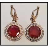 A pair of stamped 925 silver renaissance style earrings set with round faceted rubilite stones and