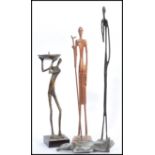 A group of three vintage 20th century bronze African figures / statues to include a candlestick