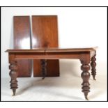 A large 19th century Victorian mahogany extending twin leaf dining table. The large, wide table