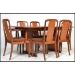 A 1970's retro teak wood dining room suite comprising a set of 6 dining chairs and an extending