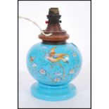 A Victorian blue glass and hand painted lamp. Of bulbous form with vivid blue glass being