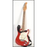 A vintage retro 20th century Shine electric guitar having a red body with white scratch guard.