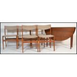 A 1970's Danish influence teak wood drop leaf dining table and chairs having the original wool
