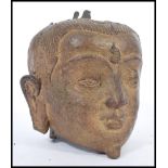 A 19th century Chinese bronze Buddha head having detailed features. 15cm high.
