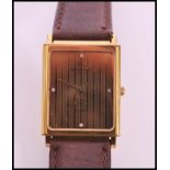 A vintage Raymond Weil 18k gold plated watch set to leather strap. Gilt dial with four white stone