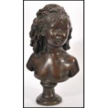 A 19th century bronze bust of a young girl with her ringlets of hair tied back, raised on a pedestal