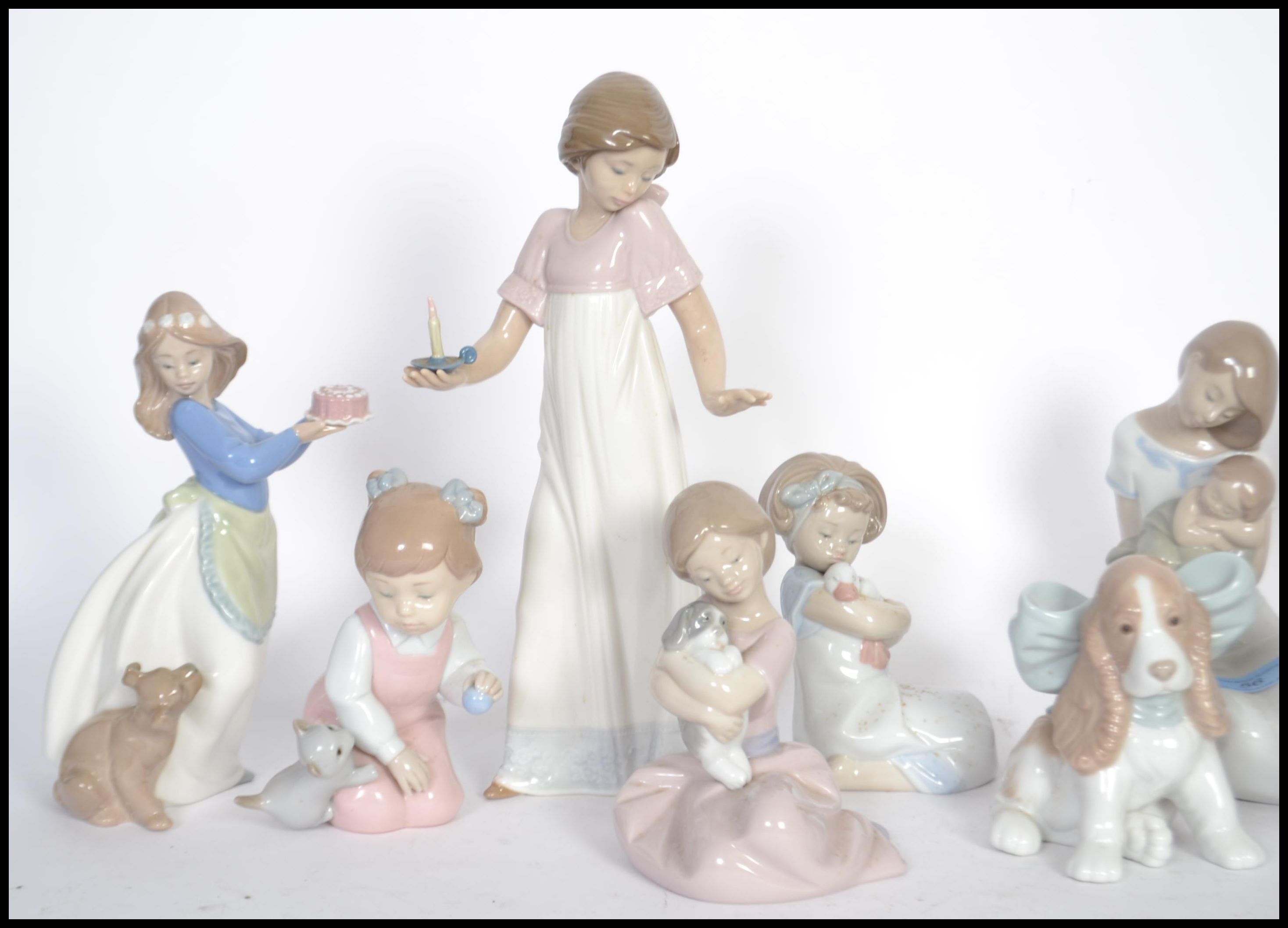 A collection of NAO ceramic figurines to include a mother and child figure, a girl holding a candle, - Image 2 of 5