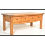 A contemporary chunky oak ' furniture land ' style coffee table of rectangular form with squared