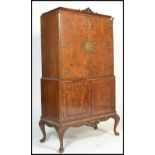 A vintage 20th century 1950's Art Deco style burr walnut tall cocktail cabinet raised on cabriole