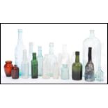A collection of vintage early 20th century advertising bottles to include Pyrex, Carter and Co