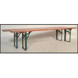 A pair of mid 20th Century Industrial factory work benches. Each of panelled wood with folding metal