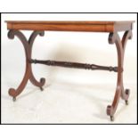 A 19th century Regency mahogany writing table desk being raised on lyre shaped supports united by