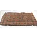 A 19th century Kazak long runner floor rug having four and a half central hooked medallions and